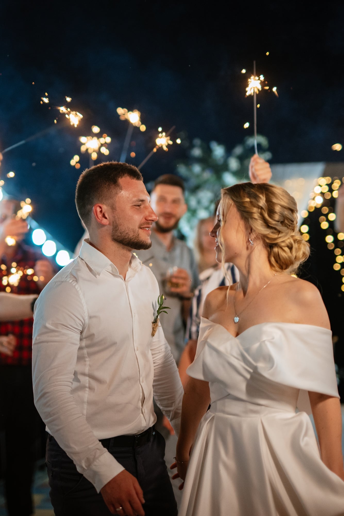 newlyweds at a wedding of sparklers